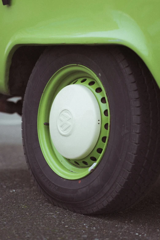 the front wheels and rim of a green vehicle