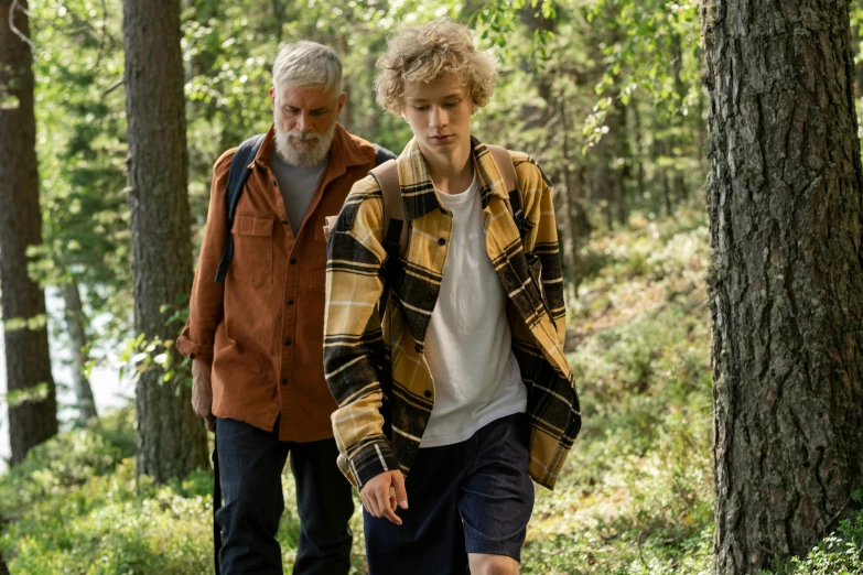 a man and his grandson hiking in the woods