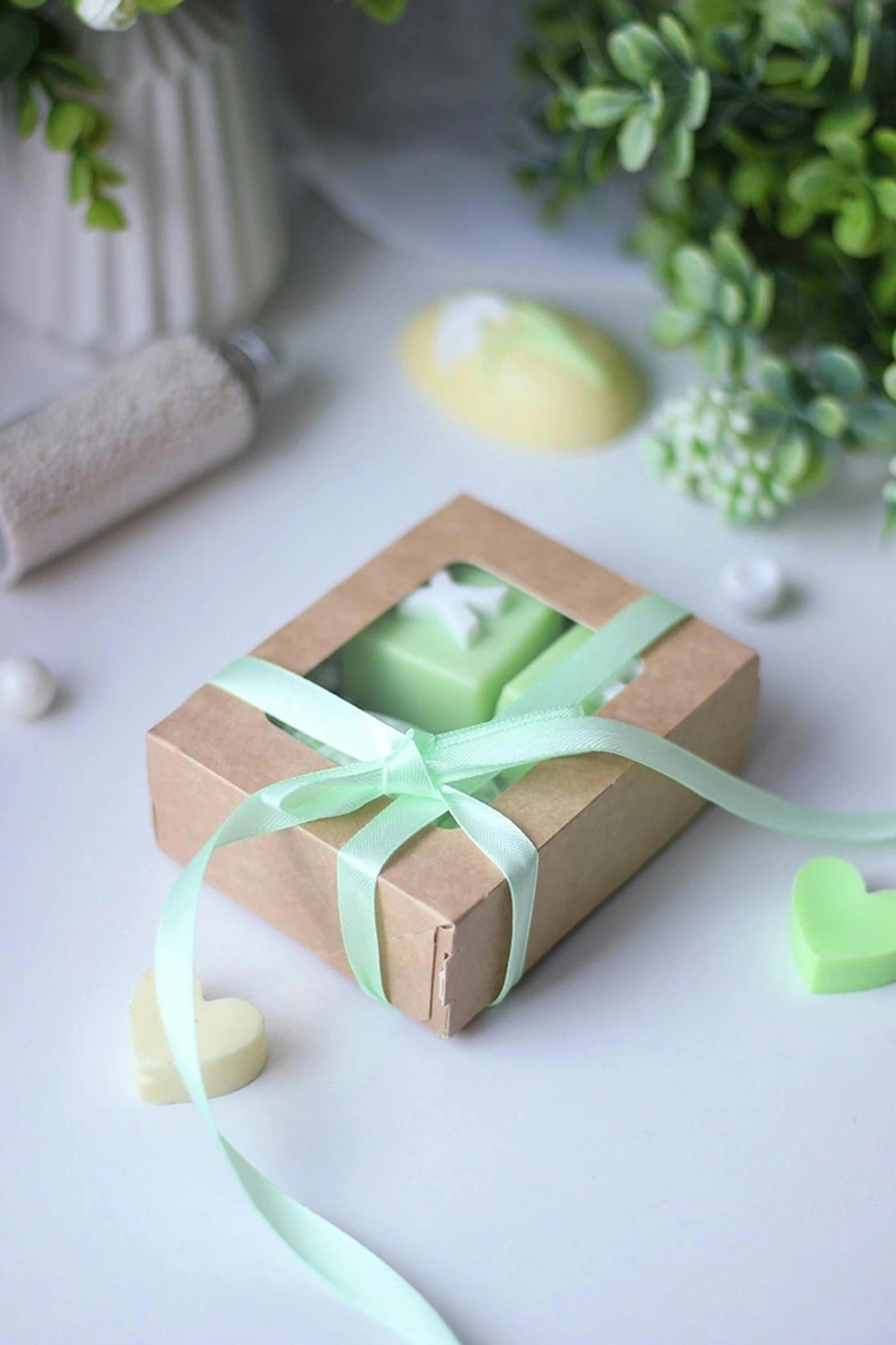 a gift box with a ribbon and a candle