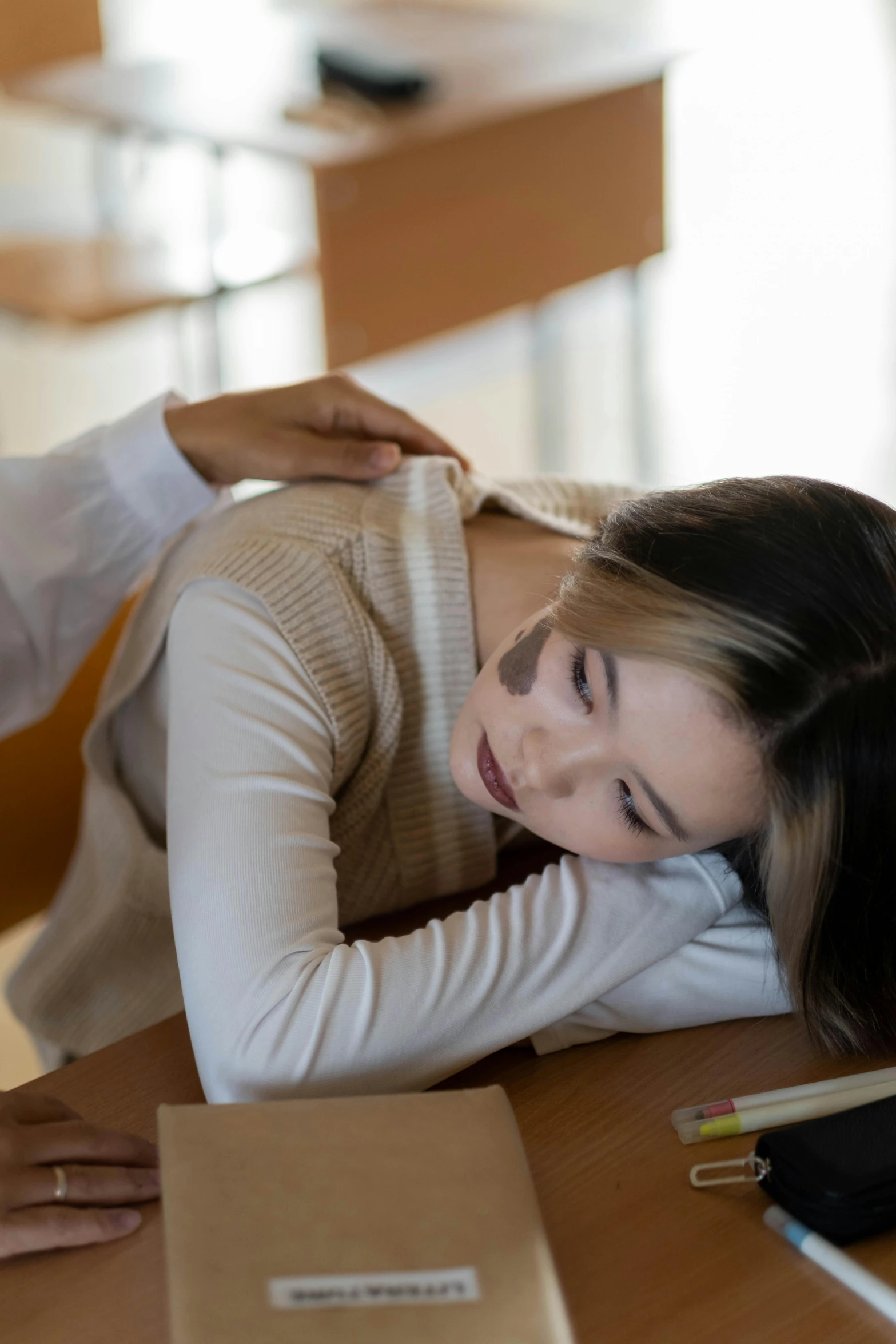 a woman laying on her back and a lady holding soing up to her face