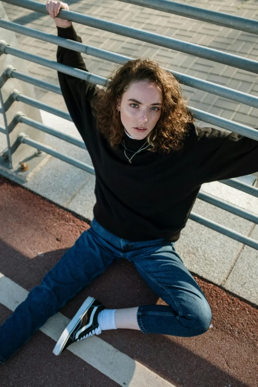 a girl posing on stairs with her arms up