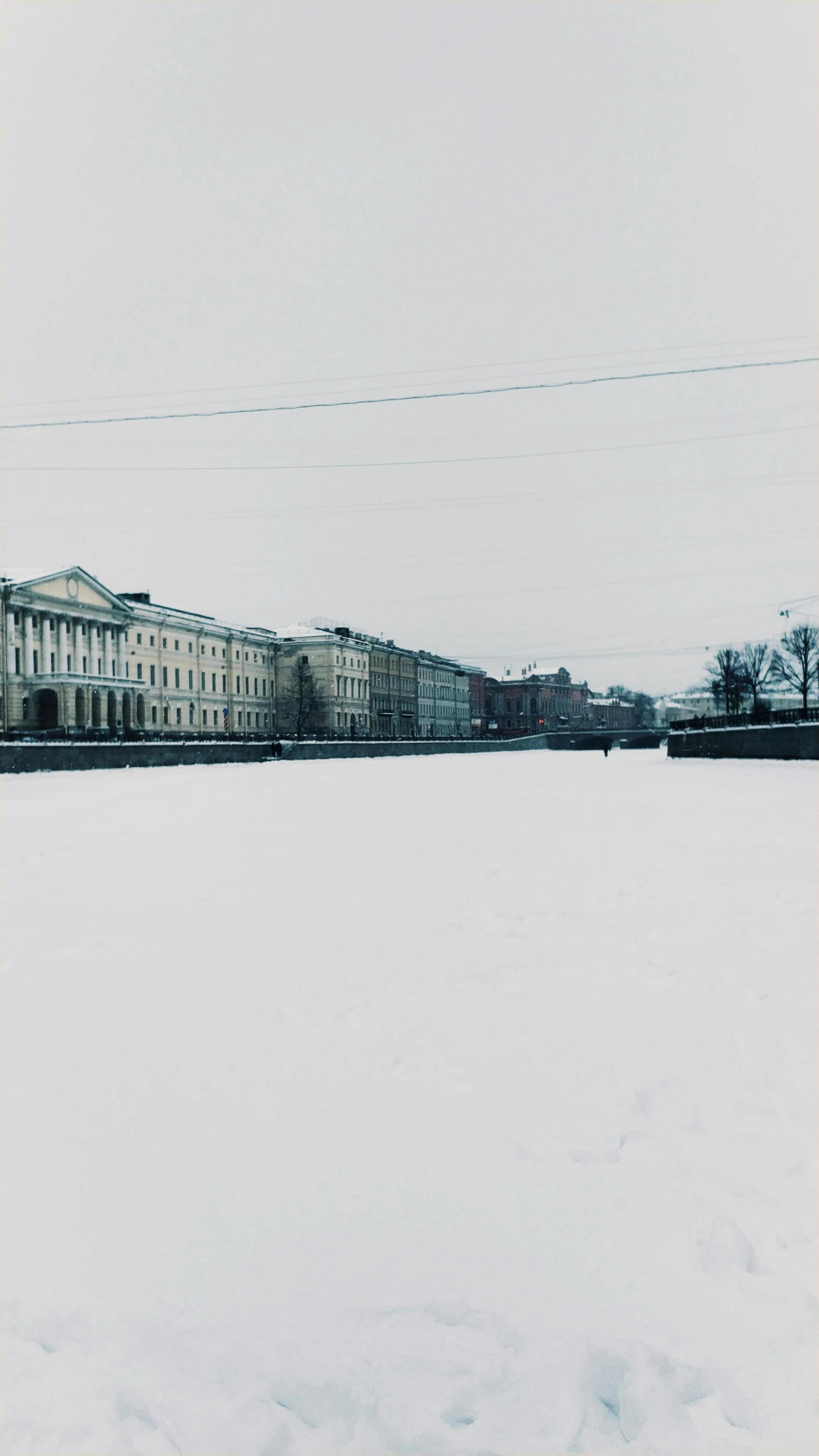 the buildings at the distance are all covered in snow