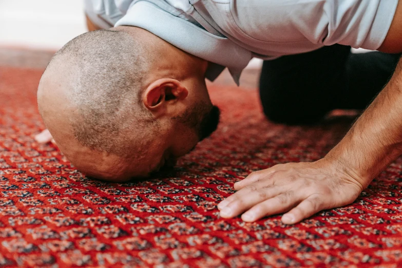 a man doing a h - up on the floor in an exercise