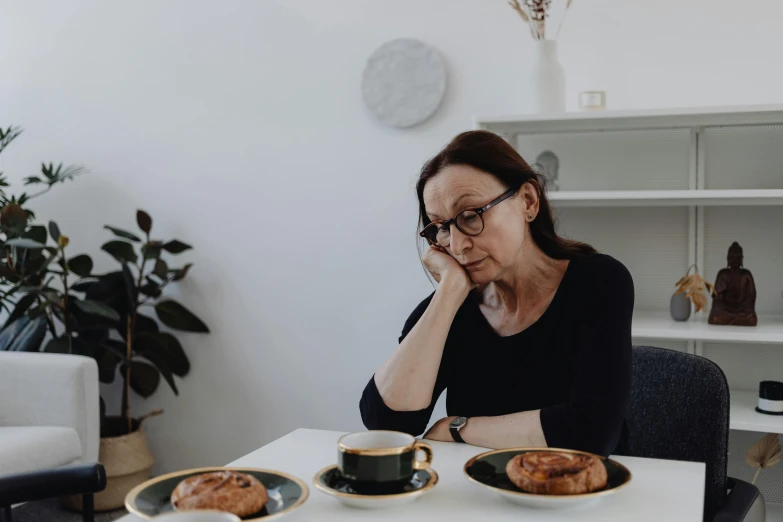 a woman is having breakfast in her office