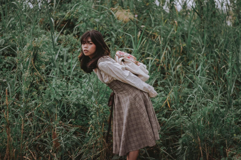 a woman is standing outside in the rain