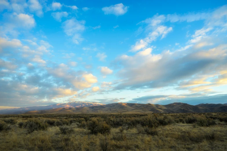 beautiful sky with clouds over the mountains below