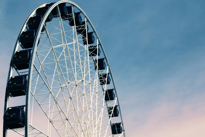 a close up of a ferris wheel against a blue sky