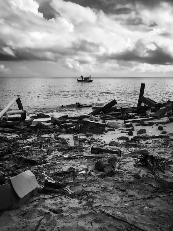 there is a broken boat and debris on the shore