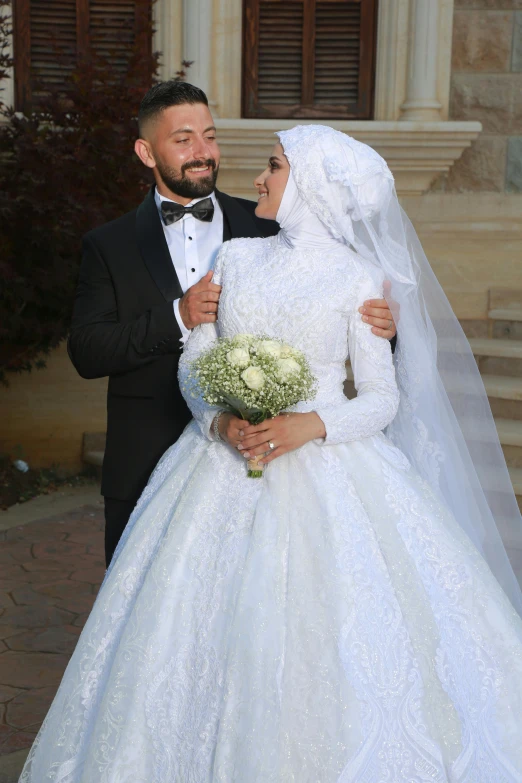 the bride and groom are dressed in wedding attire