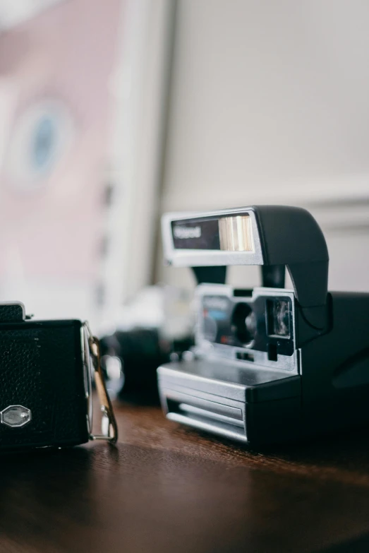 an old camera and a flash drive on a wooden table