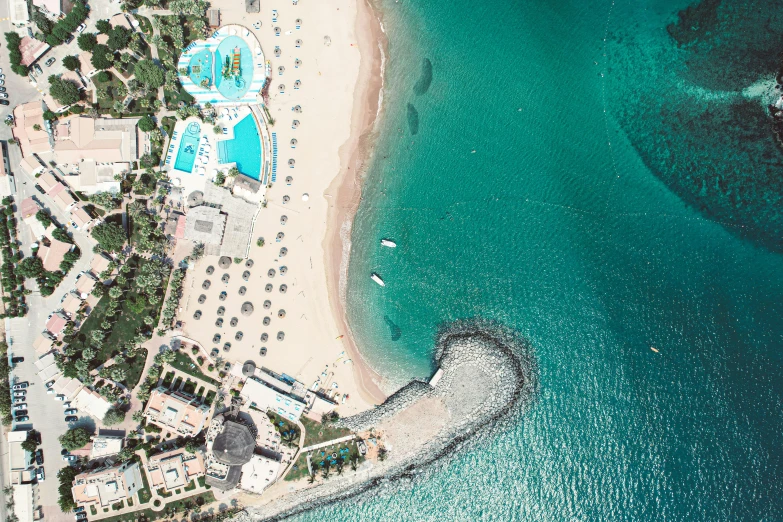 the blue sea and beach is seen from above