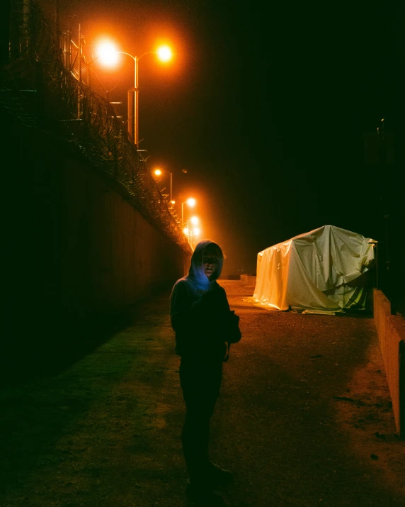 a person walking down a dark alley at night