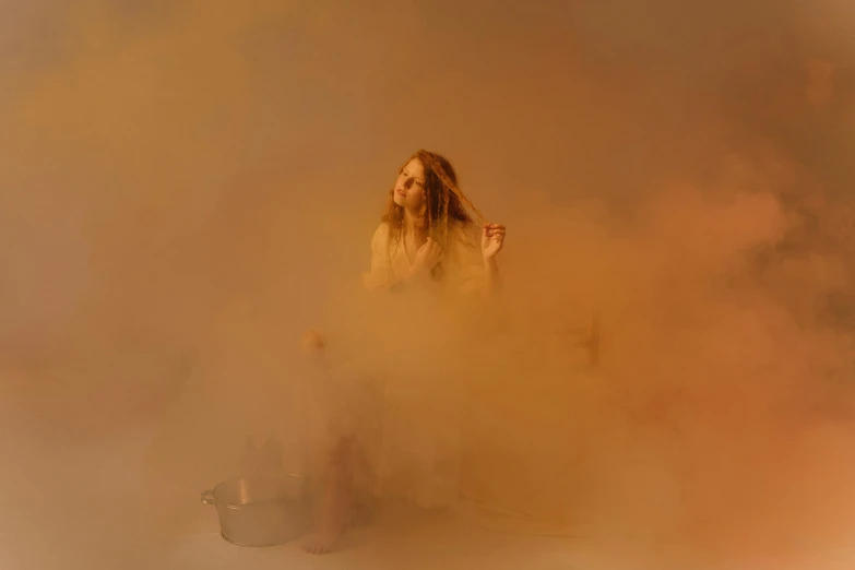 the woman is walking through the smoke with her hands on her hips