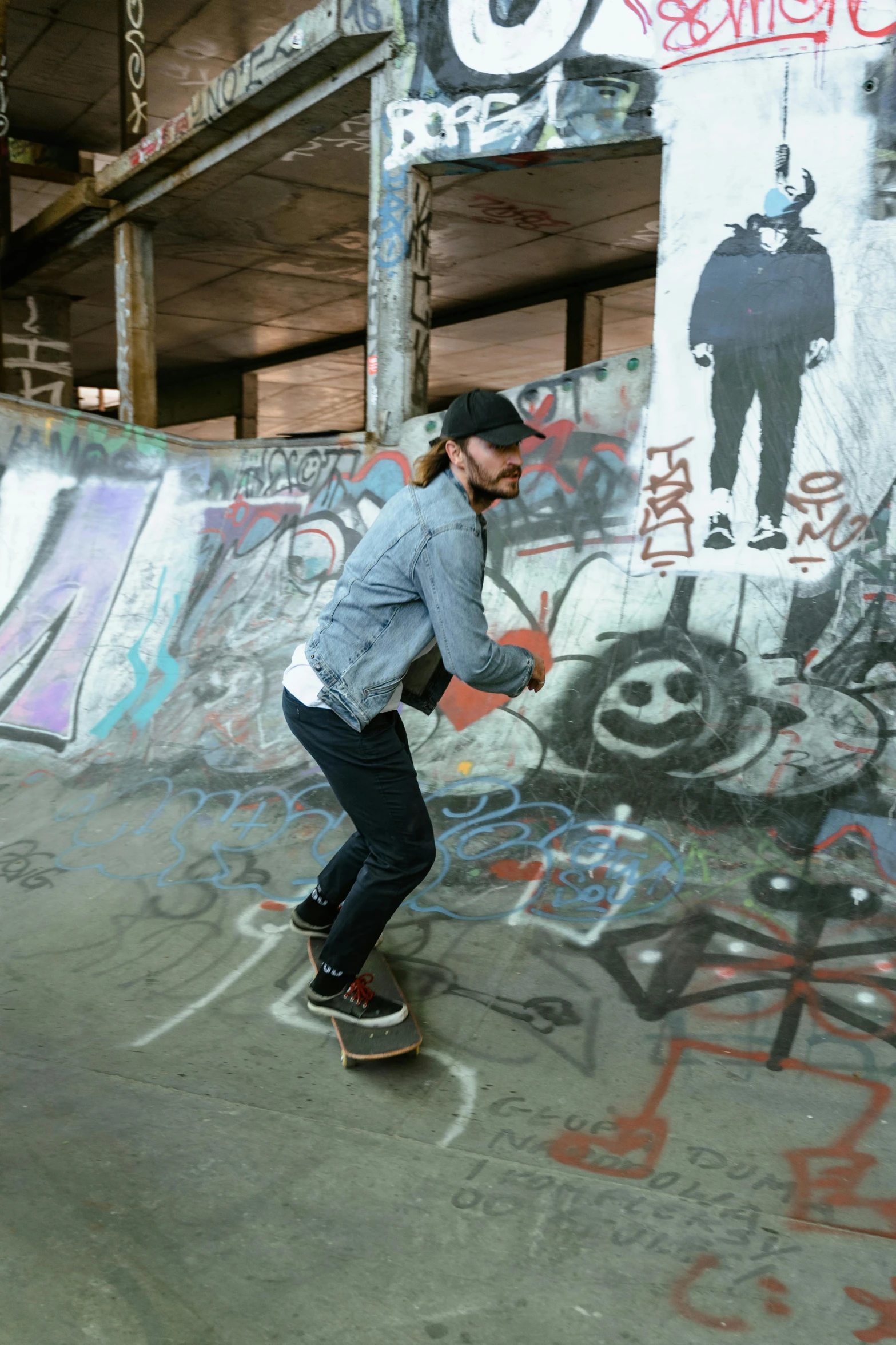 a young man skateboarding on a ramp covered in graffiti