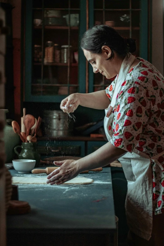 a woman is cooking in the kitchen with pots