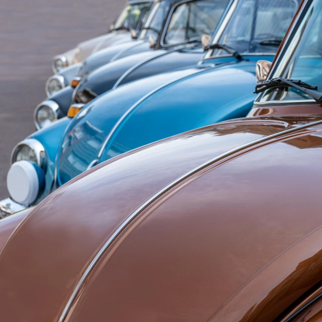 many different colored vehicles are parked together