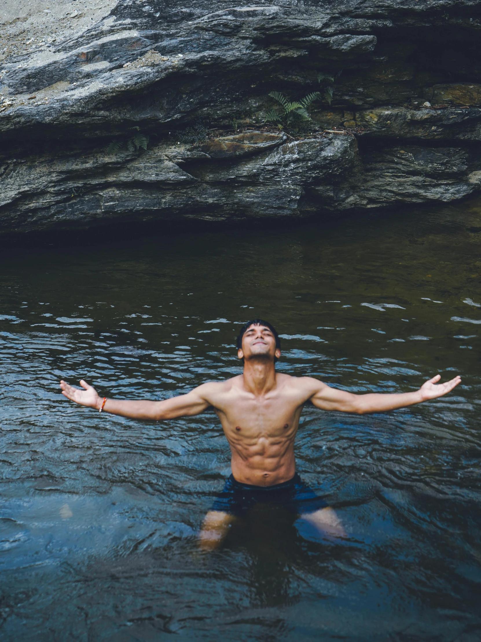 a man standing in a body of water looking up