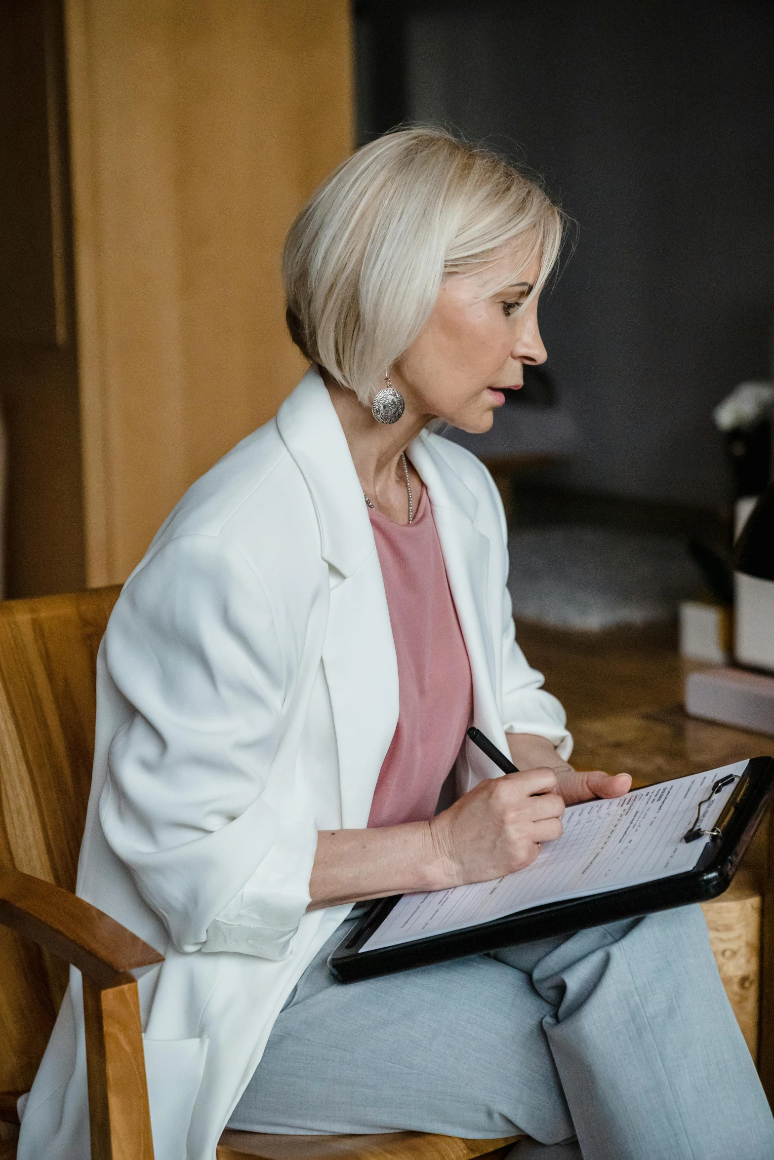 a women sitting in a chair holding a book