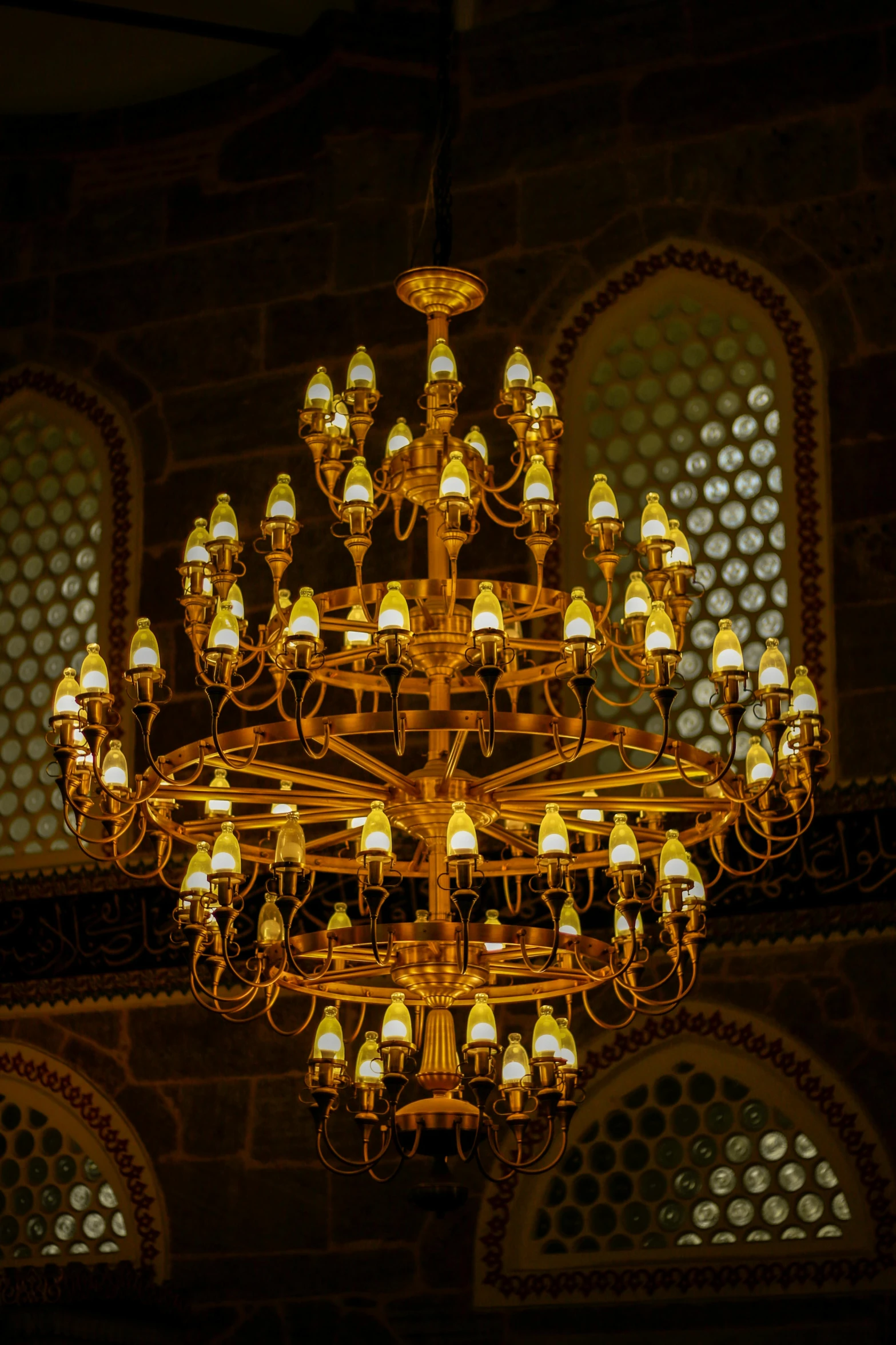 a chandelier made of many lamps lit in an old building