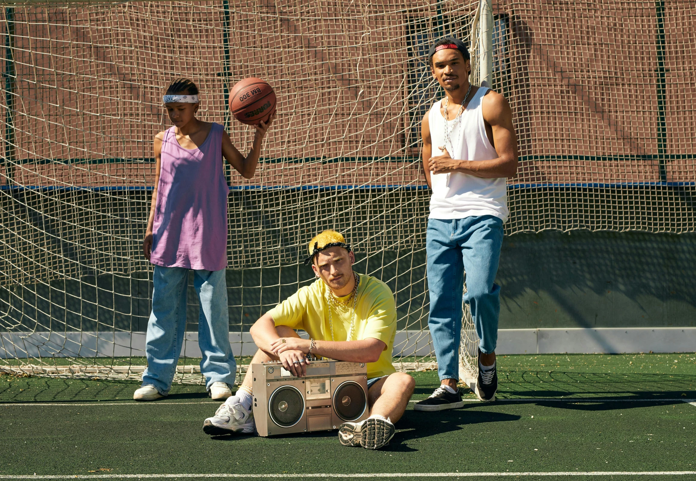 two guys with a basketball on their feet in front of net