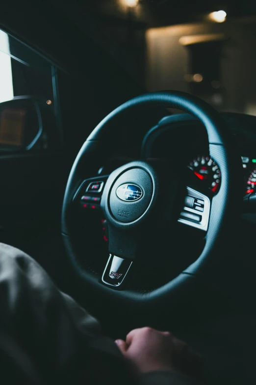 a car dashboard with a steering wheel in front of it