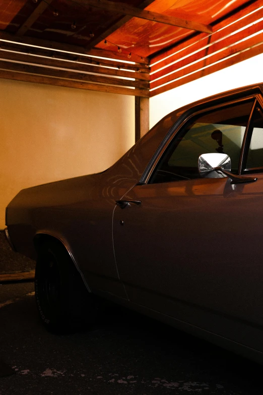 a brown car parked under a closed garage