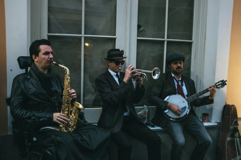 three men in suits playing music on the streets