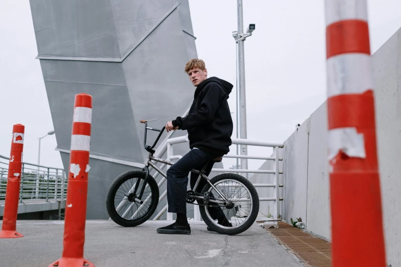 a man with short hair riding a bike