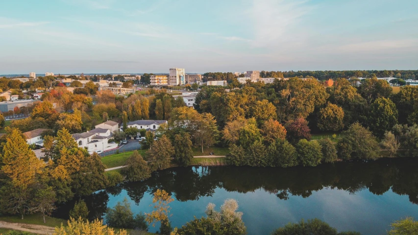 the city is surrounded by green trees and blue waters