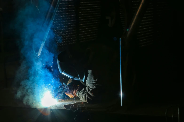 a welding worker working in the dark