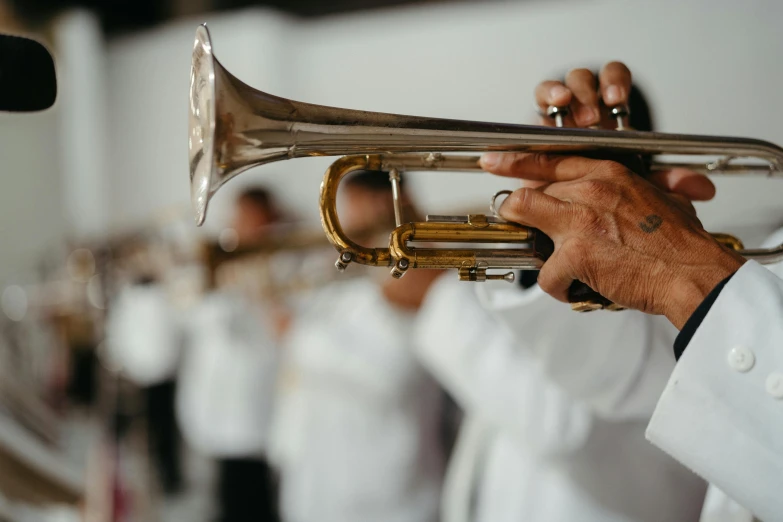 a person playing a ss trumpet in front of people