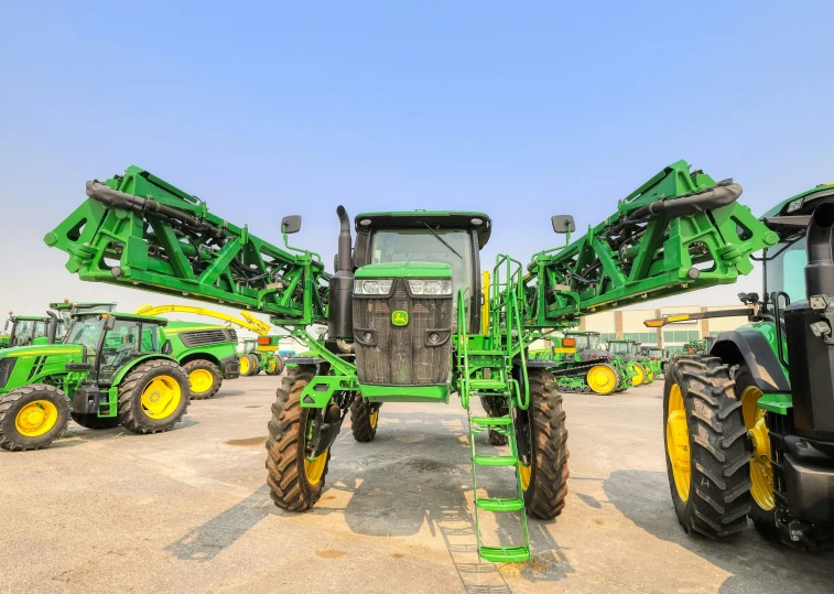 three tractors and a truck parked in dirt