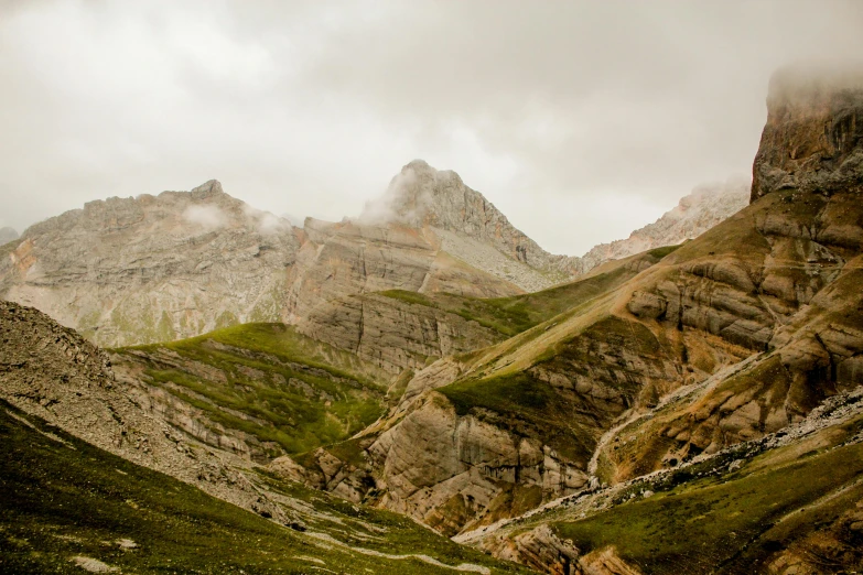 a view of some very rocky hills with low lying cloud