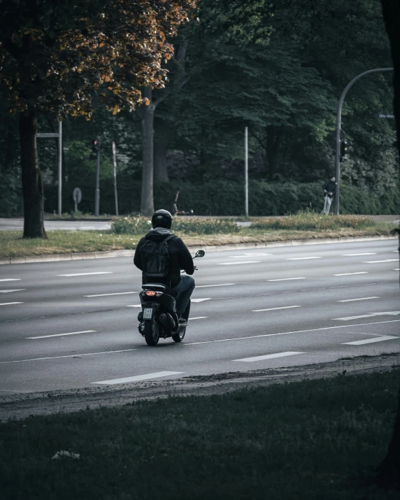 a man riding a motorcycle on a road