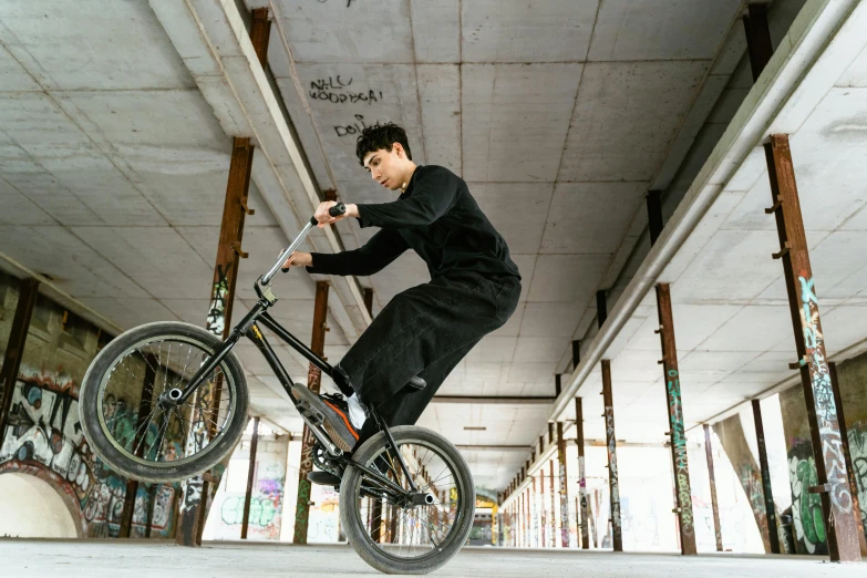 a man jumping a bike in a skate park