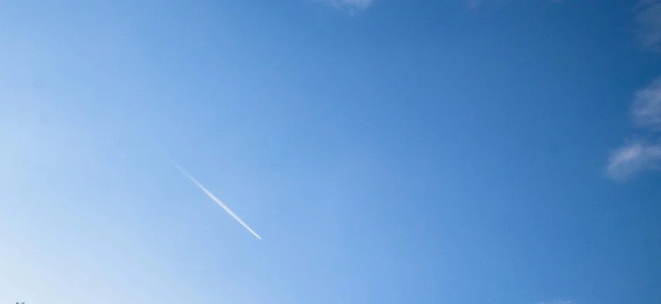 an airplane flying in the air on a cloudy day