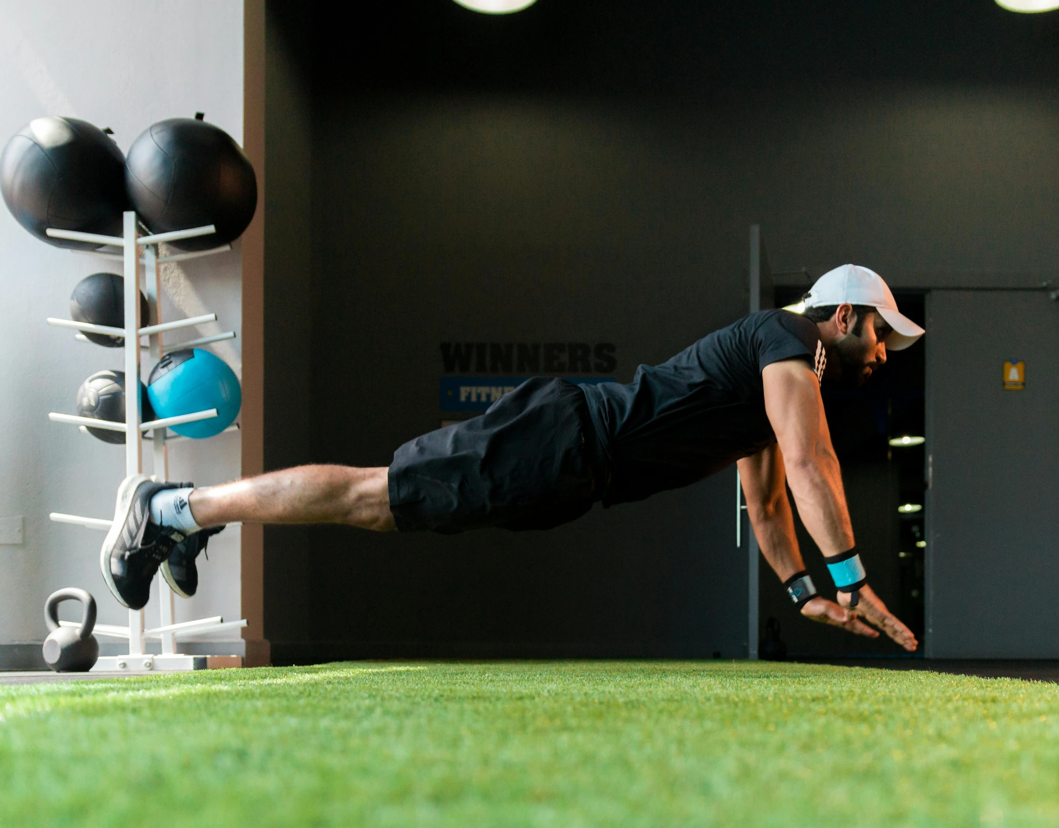 a man is doing an exercise in a green floor