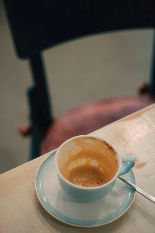 a cup of  chocolate sits on a plate