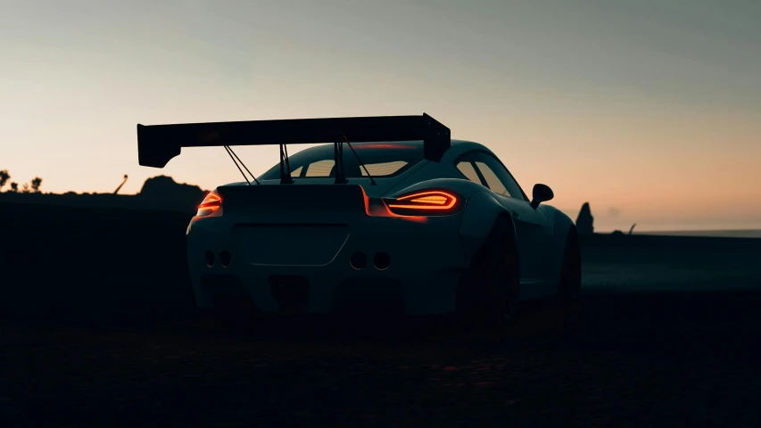 a white sports car with its lights turned on at sunset