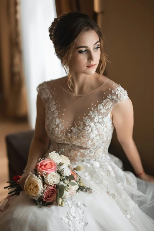 a beautiful bride posing in a white dress holding a bouquet