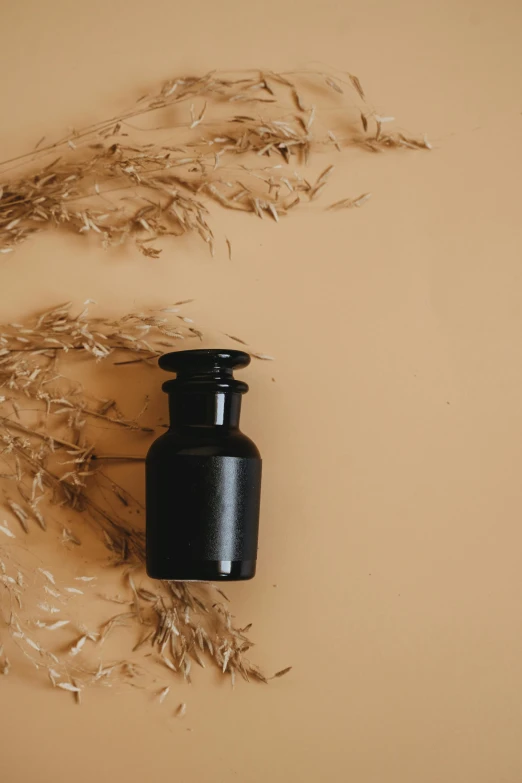 small black bottle sitting on top of a table