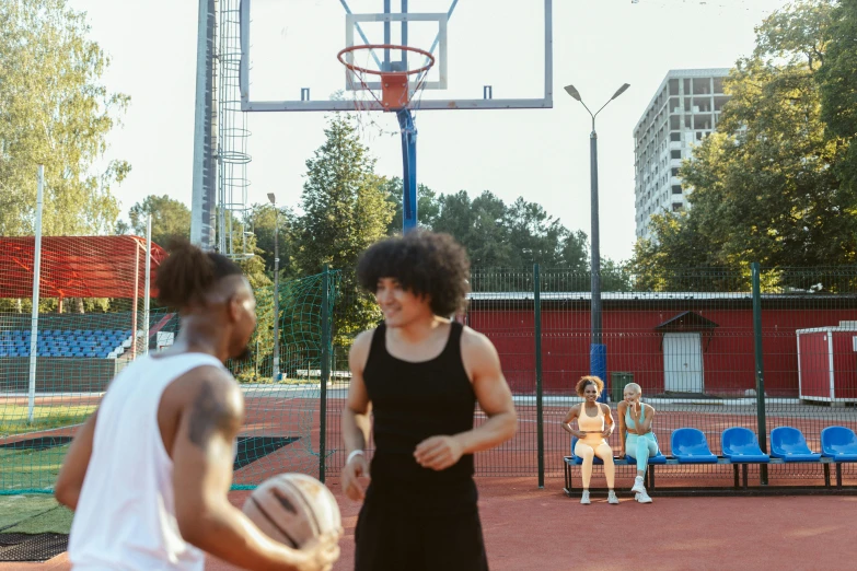 three women in black are playing basketball on a court