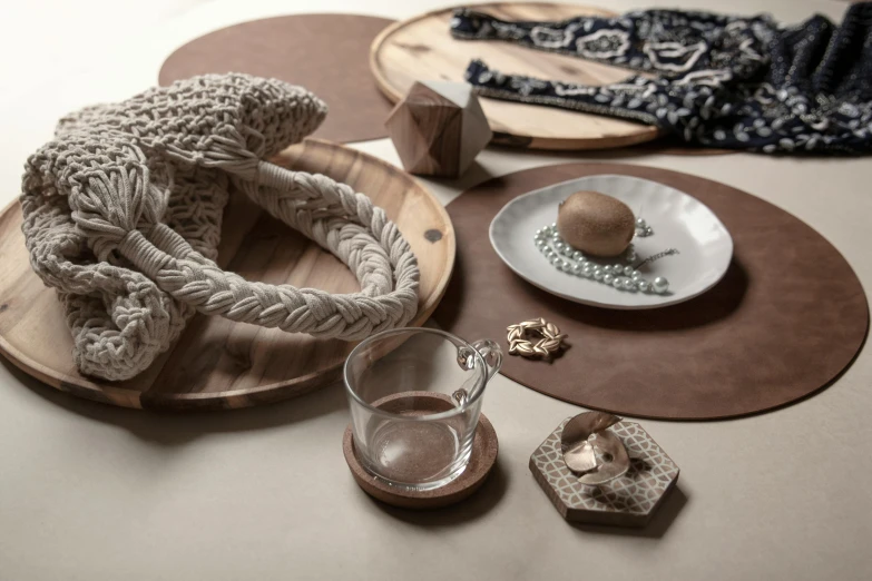 the crochet decorations are placed on wood plates and place mats