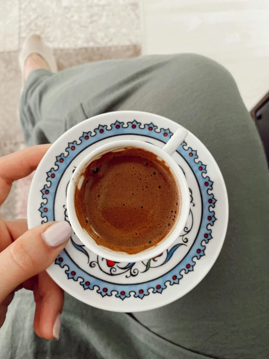 a person holding a cup of coffee