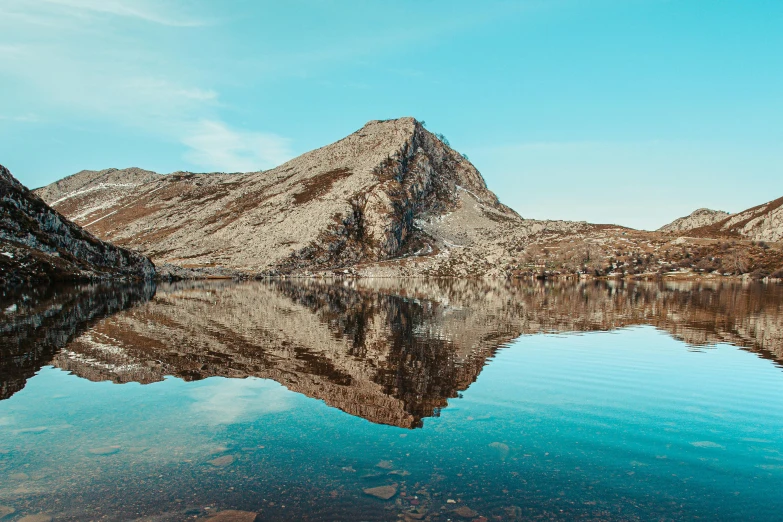 a view of mountains and water that appear to be reflecting