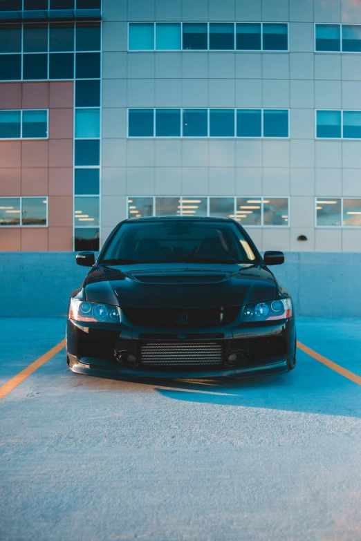 a black car parked next to a parking lot