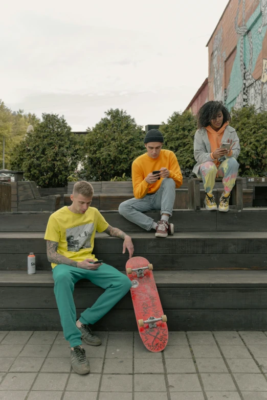 a man sitting on steps with his skateboard