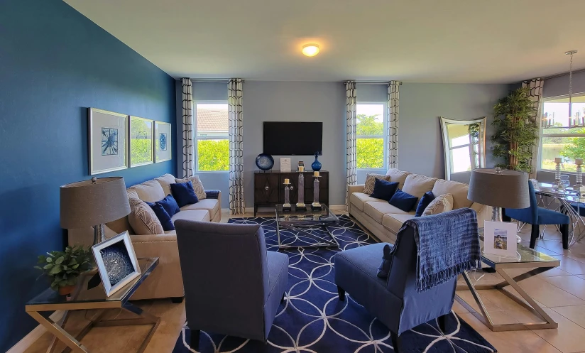 living room decorated in white and blue with chandeliers