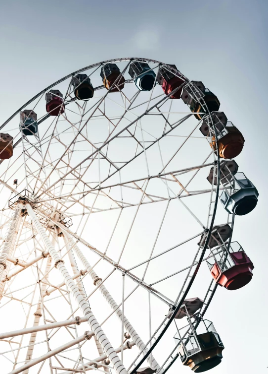 a ferris wheel on an amut park with people under it