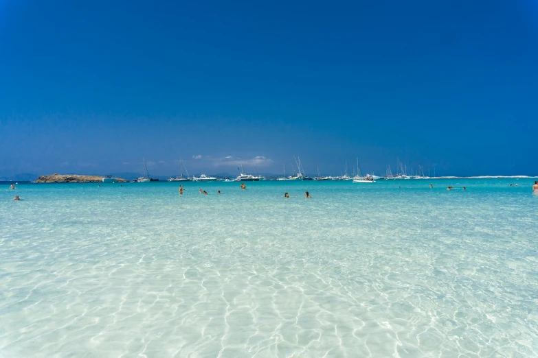 a beach with some water and boats